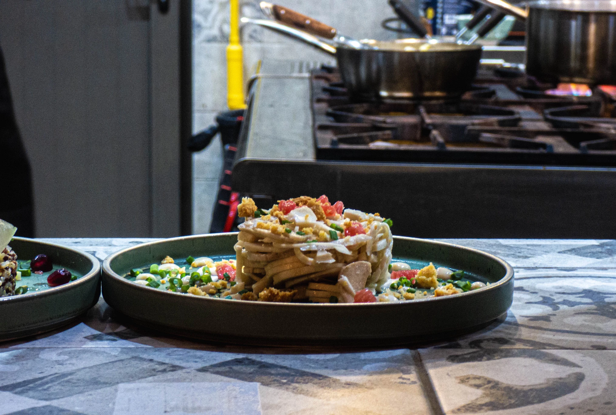 Elegant pasta creation served in the open kitchen of Wonders Beach 5-star restaurant, showcasing Mauritian culinary excellence.